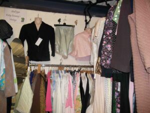 Far end of Kitty conway's stall with new stock including baby blue 1940s rayon and lace knickers and a 1940s black jacket.