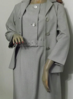 On mannequin with jacket unfastened to show dress