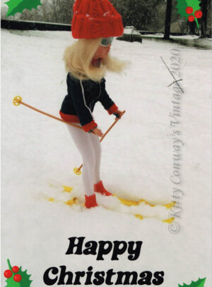Blonde Sindy in her wooly hat and anorak skis through heavy snow
