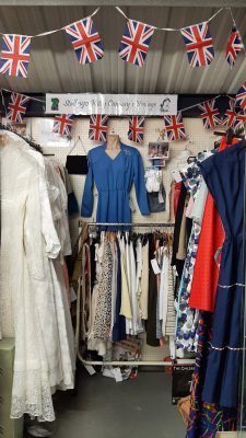 A rail of vintage wedding dresses on the left, 1950s dresses on the right and short rail of tops at the back - lots of Union Flag bunting